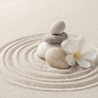 Stacked zen stones sand background art of balance concept